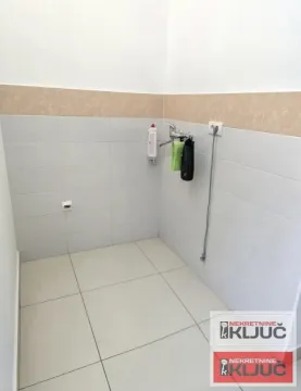 Smaller bathroom with light wall tiles and a faucet. - image 10