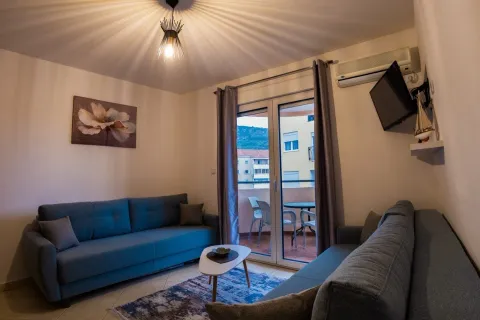 Living room with a sofa set, coffee table, and access to the terrace. - image 10