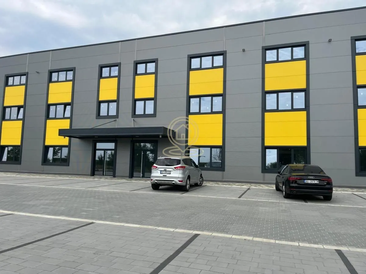Exterior of the commercial building with parking space in front of the entrance.