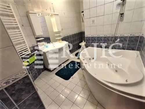 Spacious bathroom with a built-in bathtub and sink.