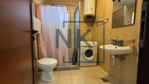Bathroom equipped with sanitary fixtures, a shower cabin with a curtain, and a washing machine. - image 8