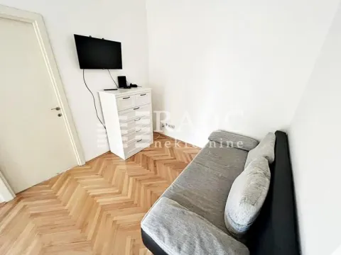 Small living room with a sofa, chest of drawers, and TV. - image 5