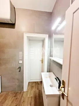 Modern bathroom with a sink and tiles. - image 11