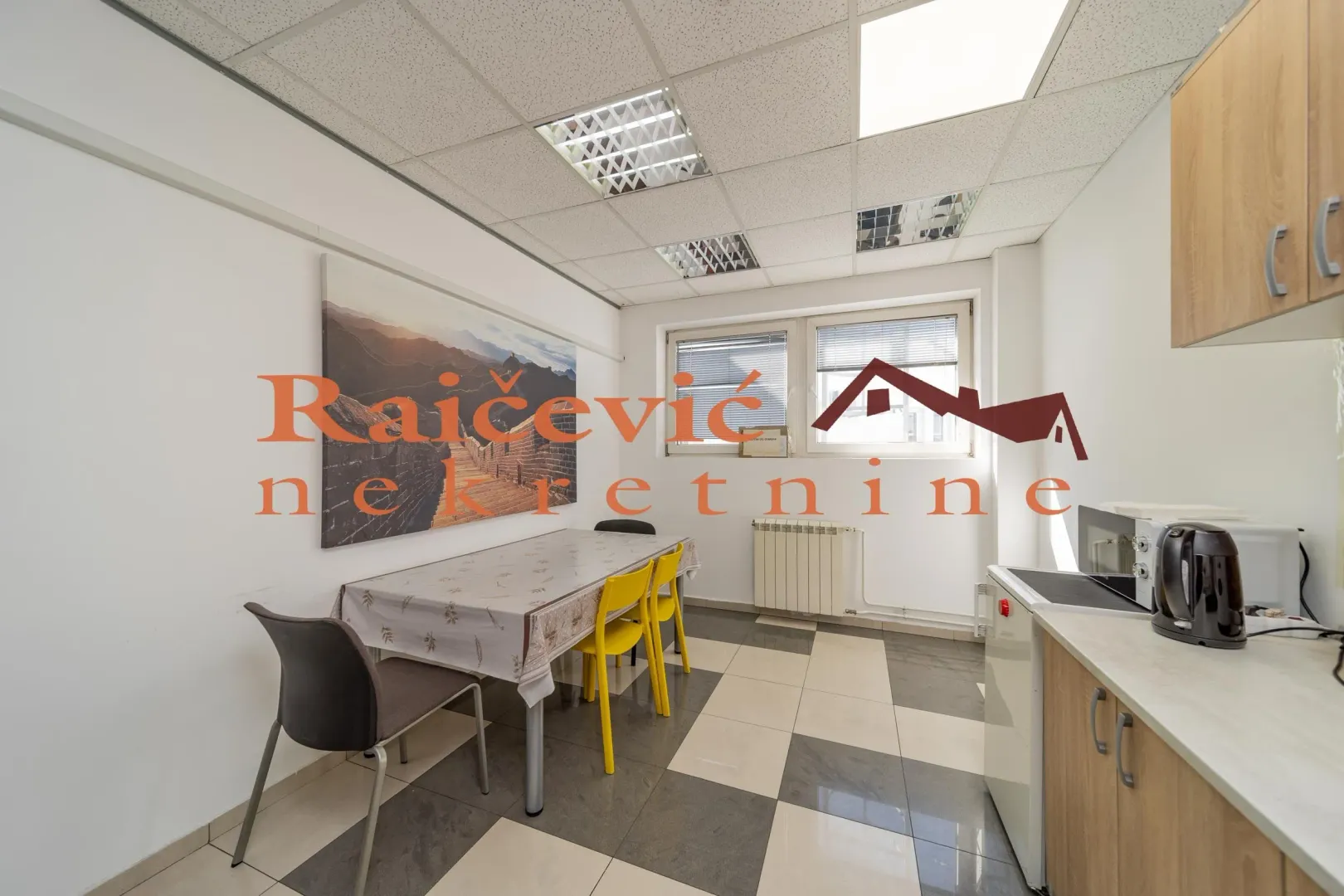 Small kitchen with a dining table and chairs.