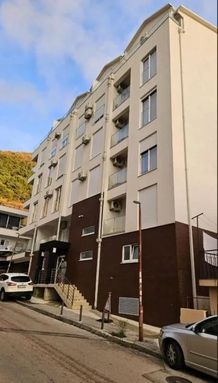 Exterior view of the residential building with balconies and entrance.