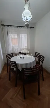 Dining area with a round table, chairs and a pendant lamp. - image 9