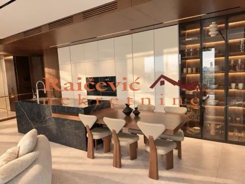 Modern kitchen with an island and dining table. - image 11