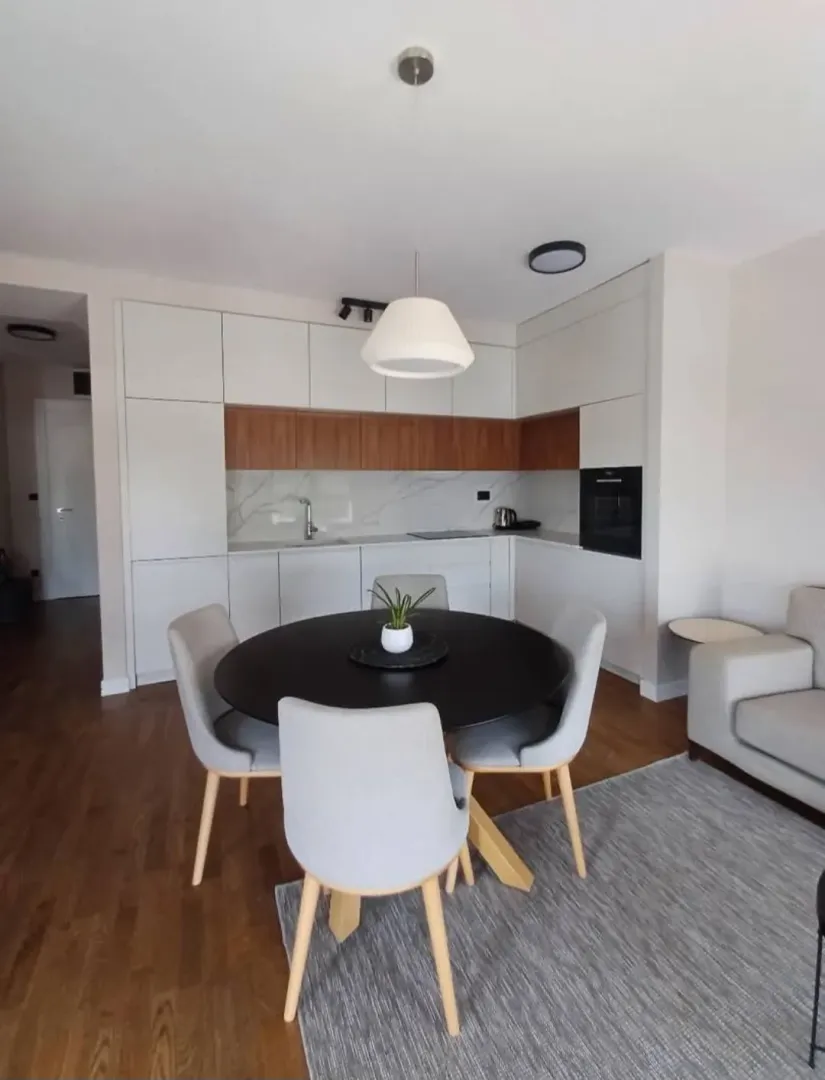 Modern kitchen with dining area and built-in appliances.