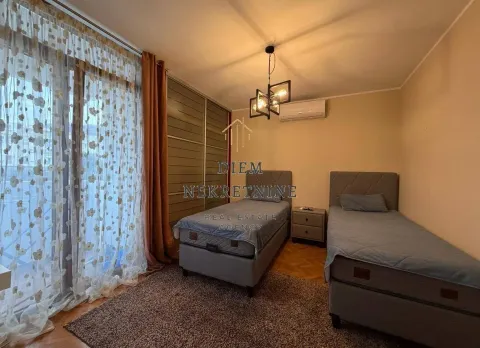 Bedroom with two beds and a wardrobe. - image 17