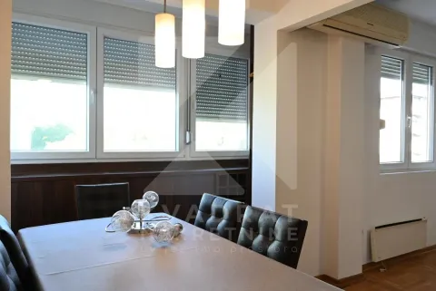 Dining area with table, chairs, and chandelier in a bright interior. - image 9
