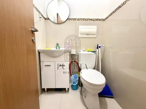 Smaller bathroom with a sink, toilet bowl, and mirror. - image 5