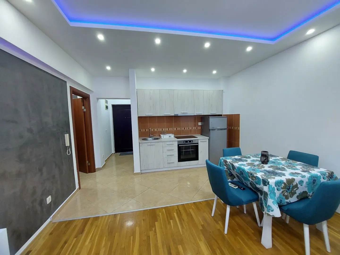 Modern kitchen with dining area and built-in appliances.