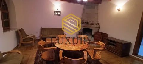 Living room with a fireplace and wooden furniture. - image 11