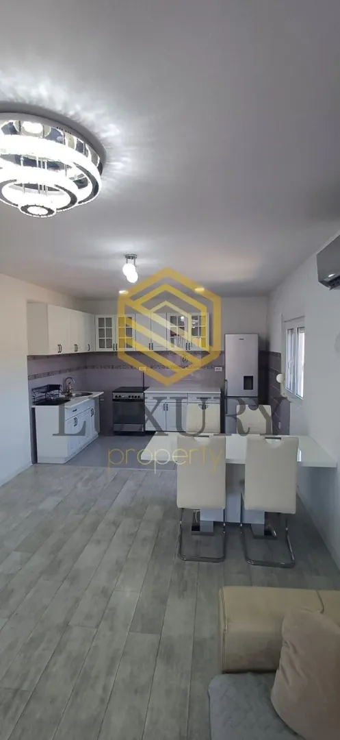 Modern kitchen connected to the dining area and living room.