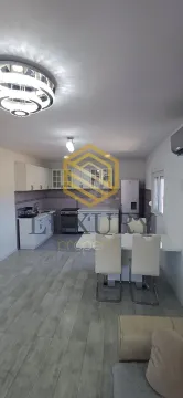 Modern kitchen connected to the dining area and living room. - image 9
