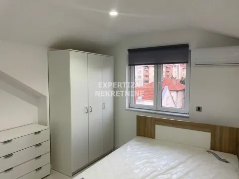 Furnished bedroom with a double bed, wardrobe, and window. - image 9