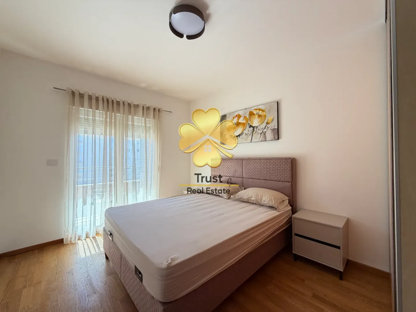 Furnished bedroom with a double bed and a nightstand.