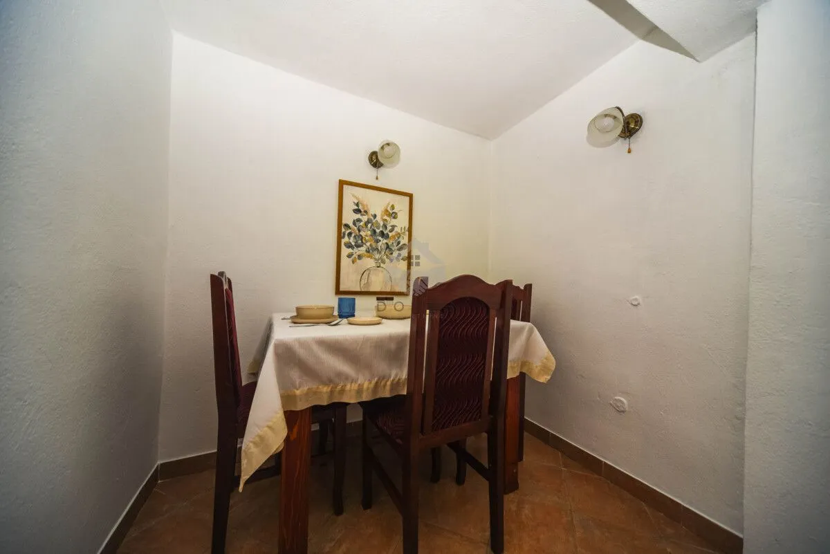 Small dining area with a wooden table and chairs.
