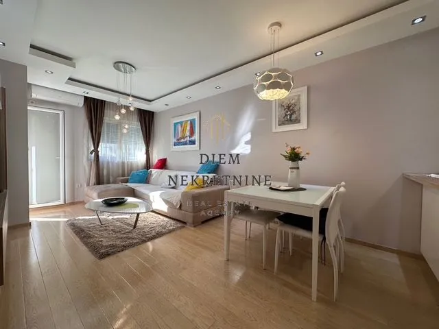 Living room with a sofa and a dining table.