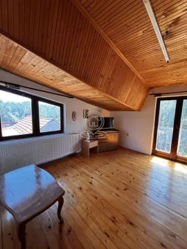 Living room with wooden paneling on the ceiling and solid wood flooring. - image 14