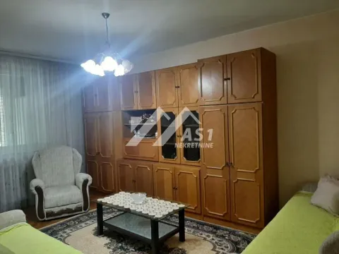 Dnevna soba sa velikim drvenim ormarom, foteljom i stočićem. - image 2