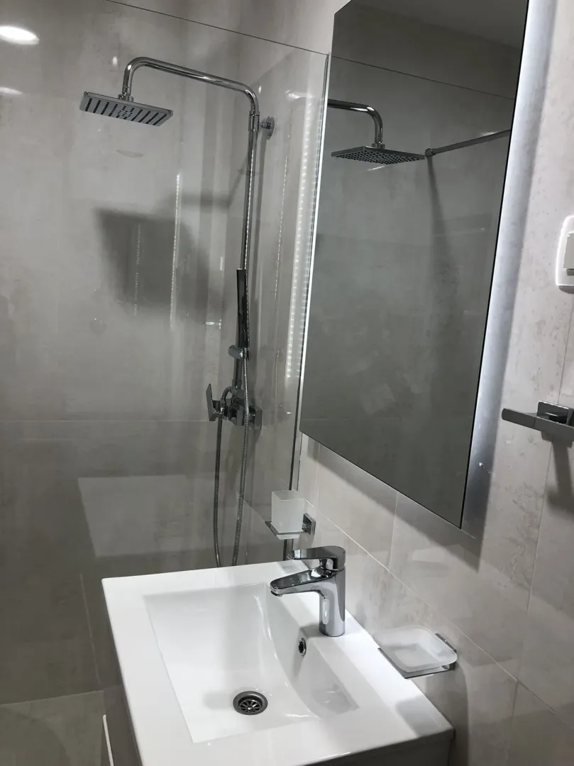 Modern bathroom with a shower and sink.
