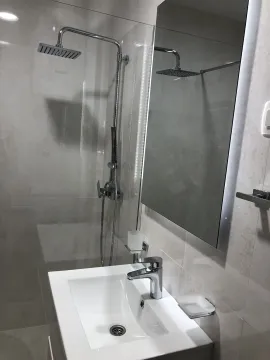 Modern bathroom with a shower and sink. - image 14