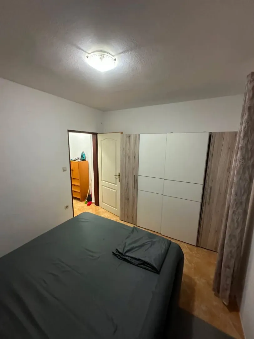 Bedroom with a double bed and a wardrobe.