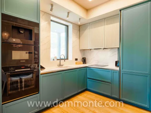 Modern kitchen with blue cabinetry and built-in appliances. - image 2