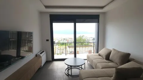 Living room with sofa, TV, and access to a terrace with a view. - image 3