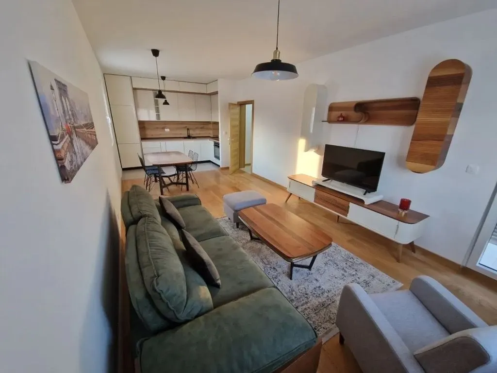 Modern living room connected to the kitchen and dining area.