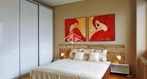 Furnished bedroom with a double bed, large wardrobe, and paintings on the wall. - image 8