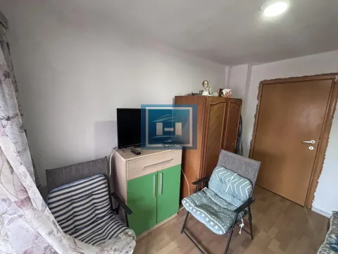 Manja dnevna soba sa televizorom, nameštajem i drvenim vratima. - image 17