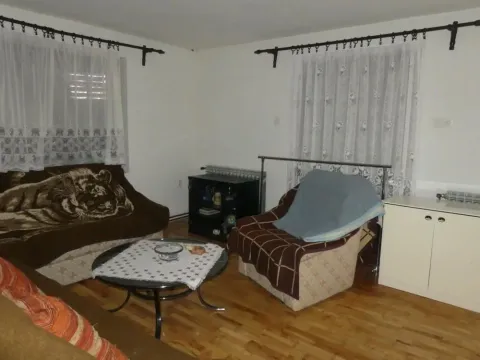 Living room with seating furniture, coffee table, and windows. - image 21