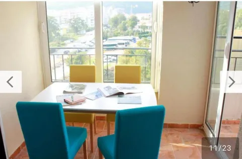 Dining area with a table, chairs, and a view of the surroundings. - image 17