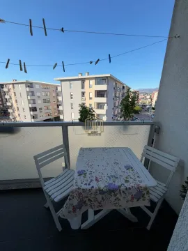 Manji balkon sa stolom, stolicama i pogledom na naselje. - image 10