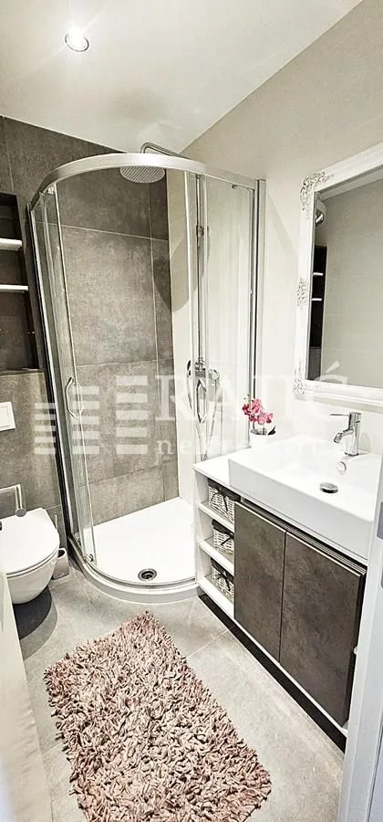 Modern equipped bathroom with a shower cabin.