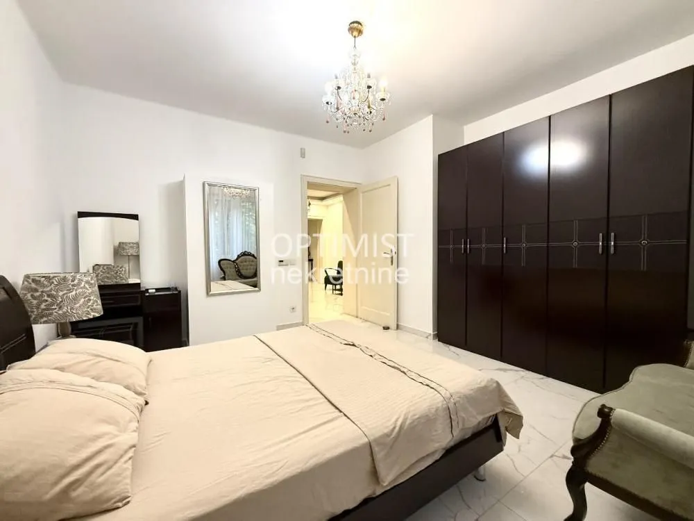 Furnished bedroom with a large double bed and wardrobe.