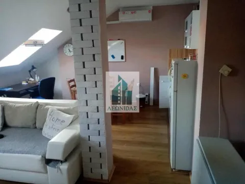 View of the living room with a sofa and work corner in the attic. - image 4