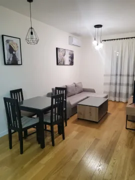 Living room with dining area, sofa and wooden floor. - image 3