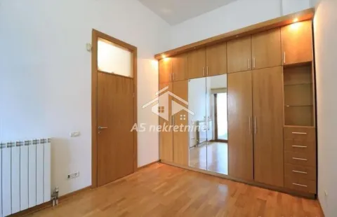 Bedroom with a large wooden wardrobe and parquet flooring. - image 16