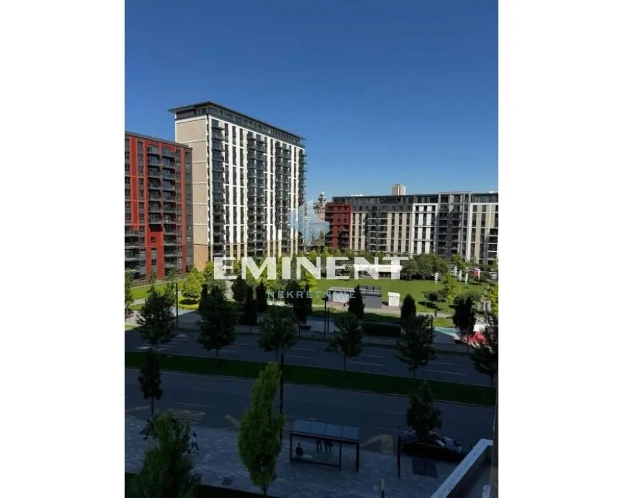 View from the window overlooking surrounding buildings and park.