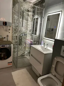 Moderno opremljeno kupatilo sa tuš kabinom, umivaonikom i veš mašinom. - image 14