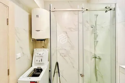 Bathroom with a shower cabin, water heater, and washing machine. - image 3