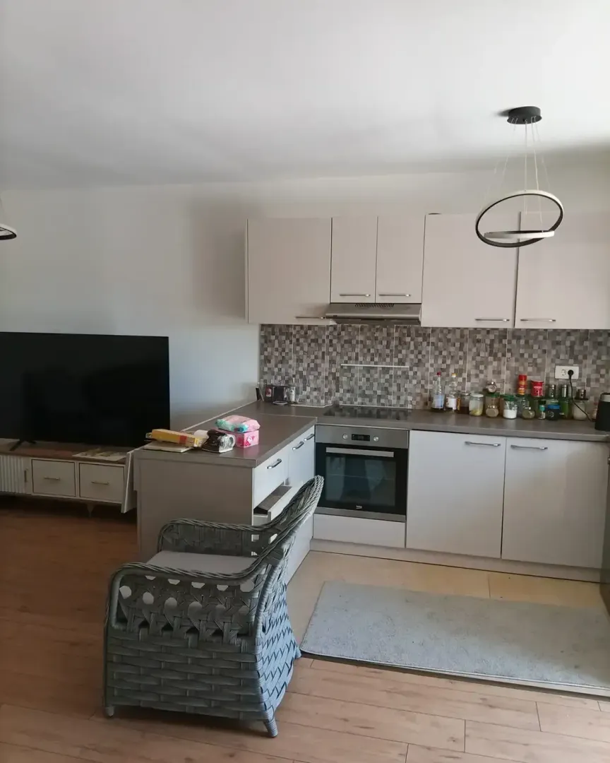 Modern kitchen with built-in appliances and dining area.