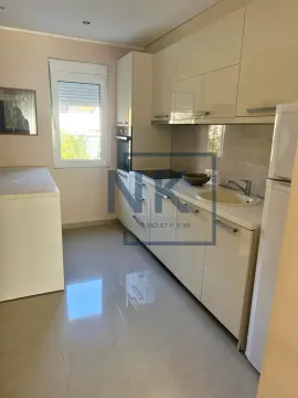 Smaller kitchen with light-colored cabinets and a window. - image 5