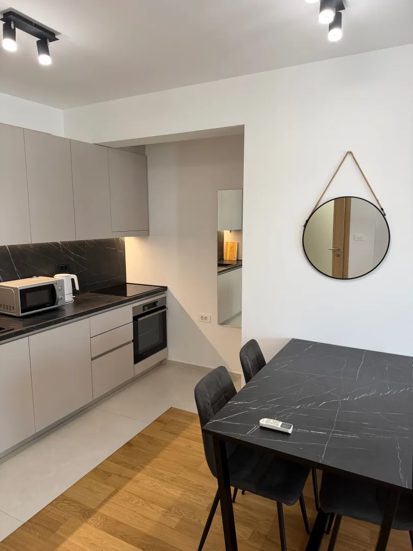 Modern kitchen with a dining table and built-in appliances.