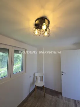 Small room with a window, a white door, and modern ceiling lighting. - image 18