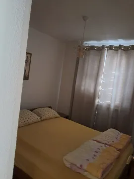 Small bedroom with a double bed and a window with curtains. - image 8