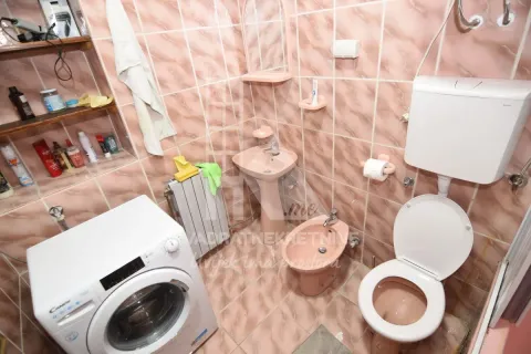 Bathroom equipped with sanitary fixtures, washbasin, toilet bowl, bidet, and washing machine. - image 11